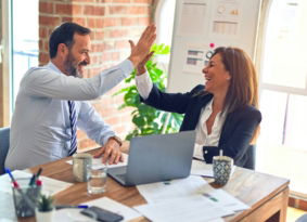 man in white dress shirt sitting beside woman in black long sleeve shirt